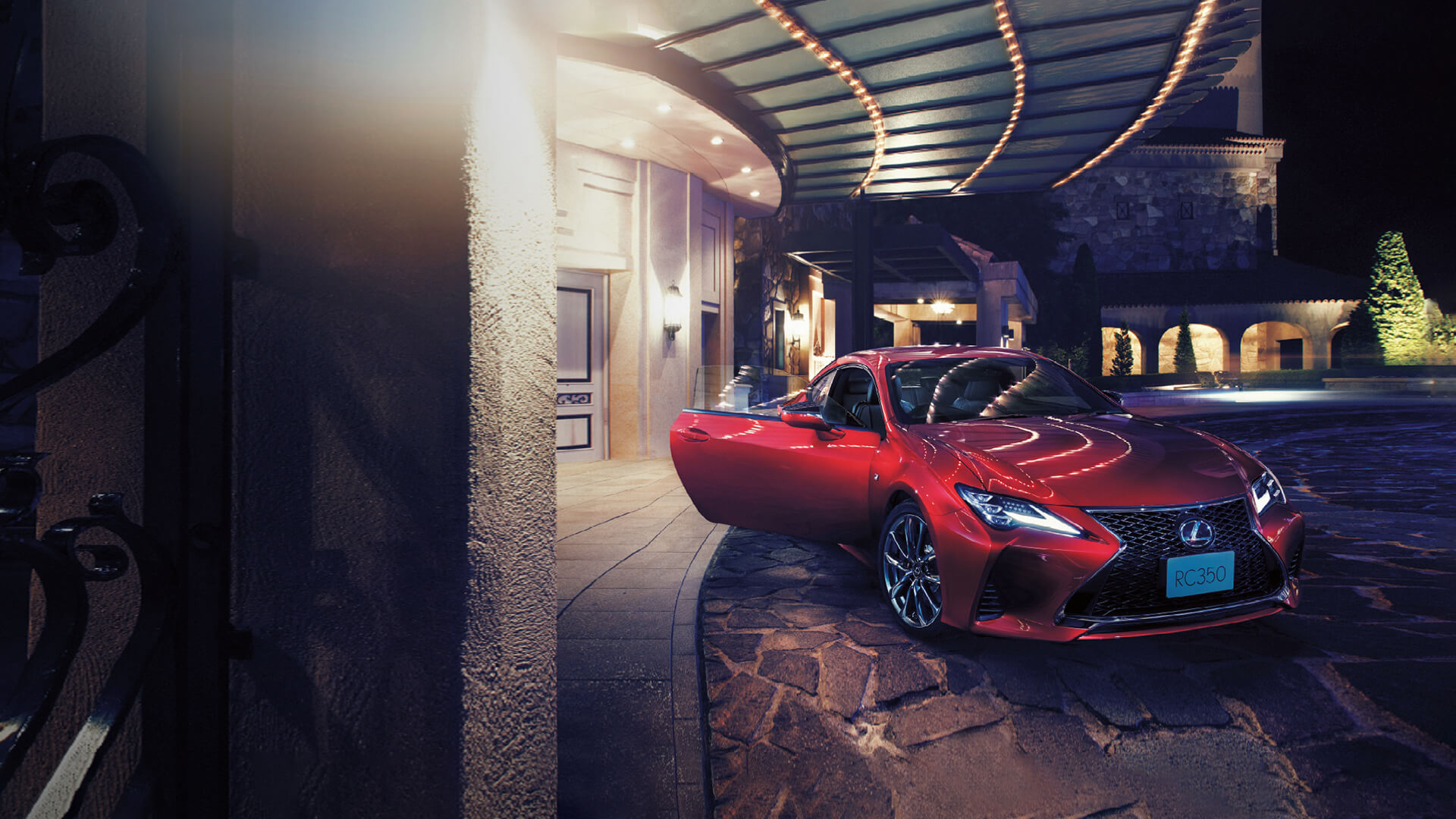 Red Lexus RC parked outside a building with the door open.